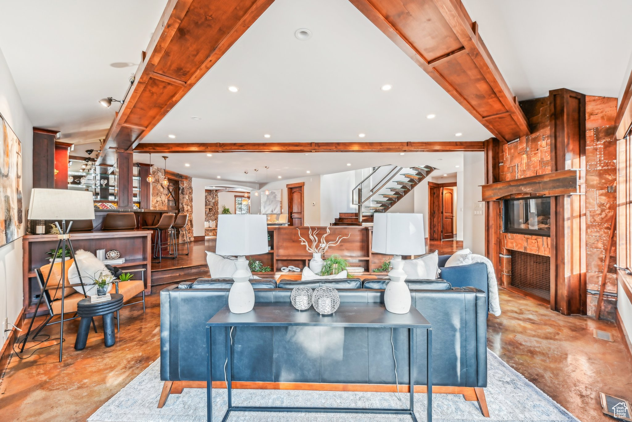 Living room with beamed ceiling and a fireplace