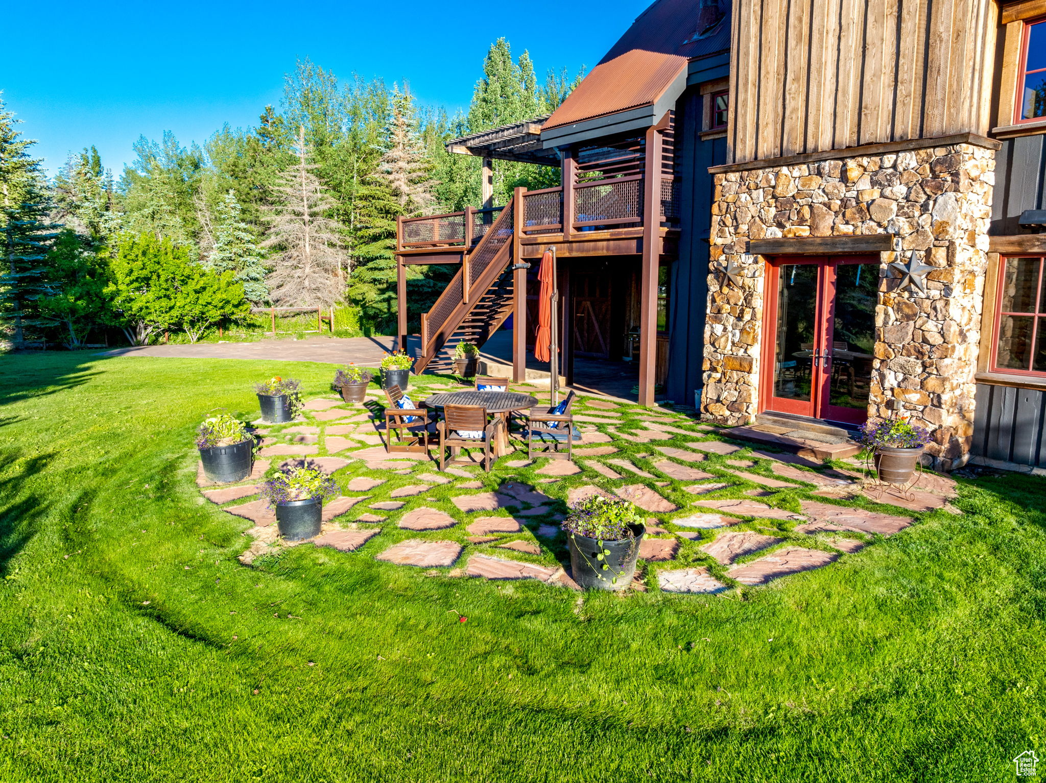 View of yard with french doors, a patio, and a deck