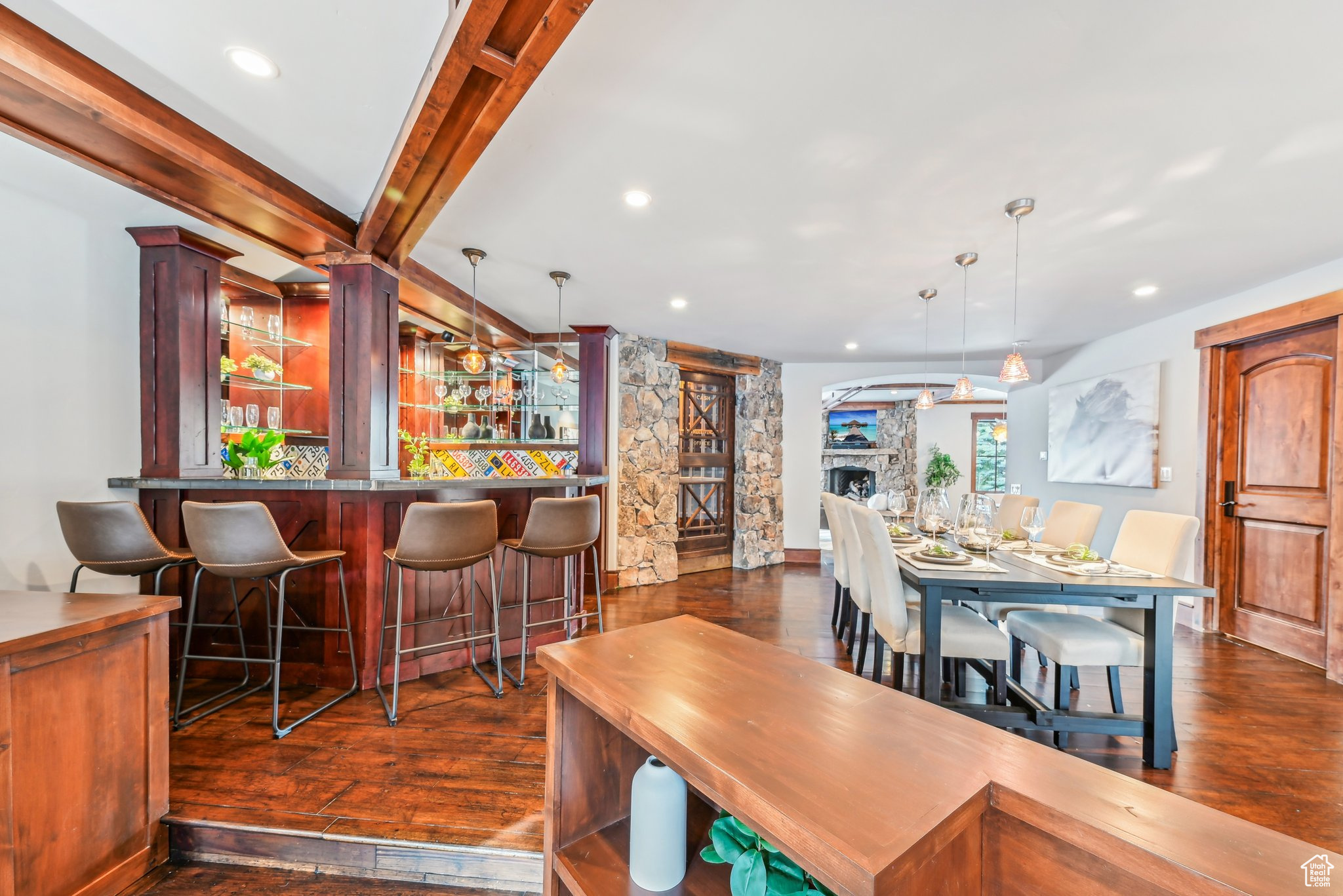 Dining area with beam ceiling, a fireplace, and dark hardwood / wood-style floors