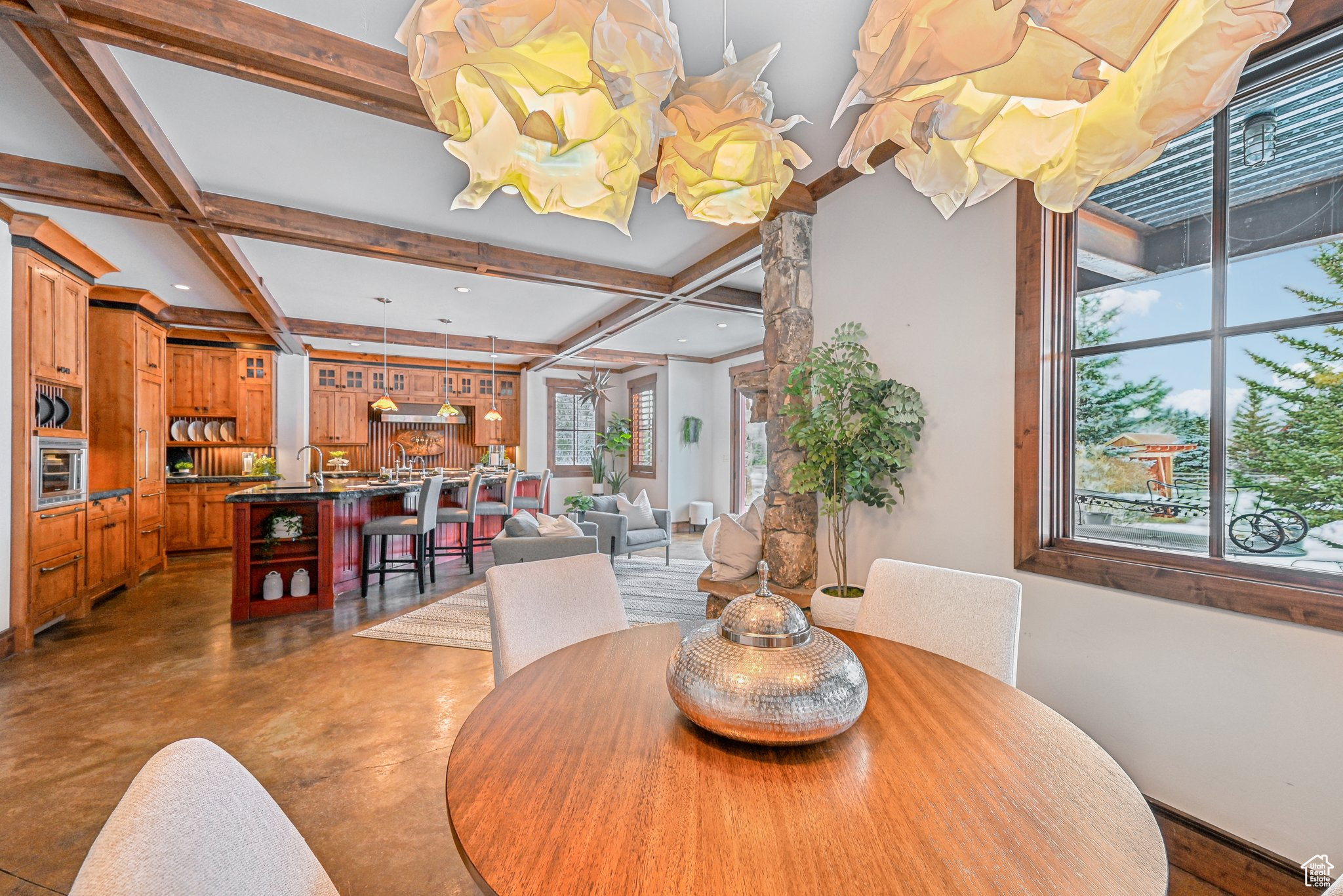 Dining area with beam ceiling, sink, and coffered ceiling