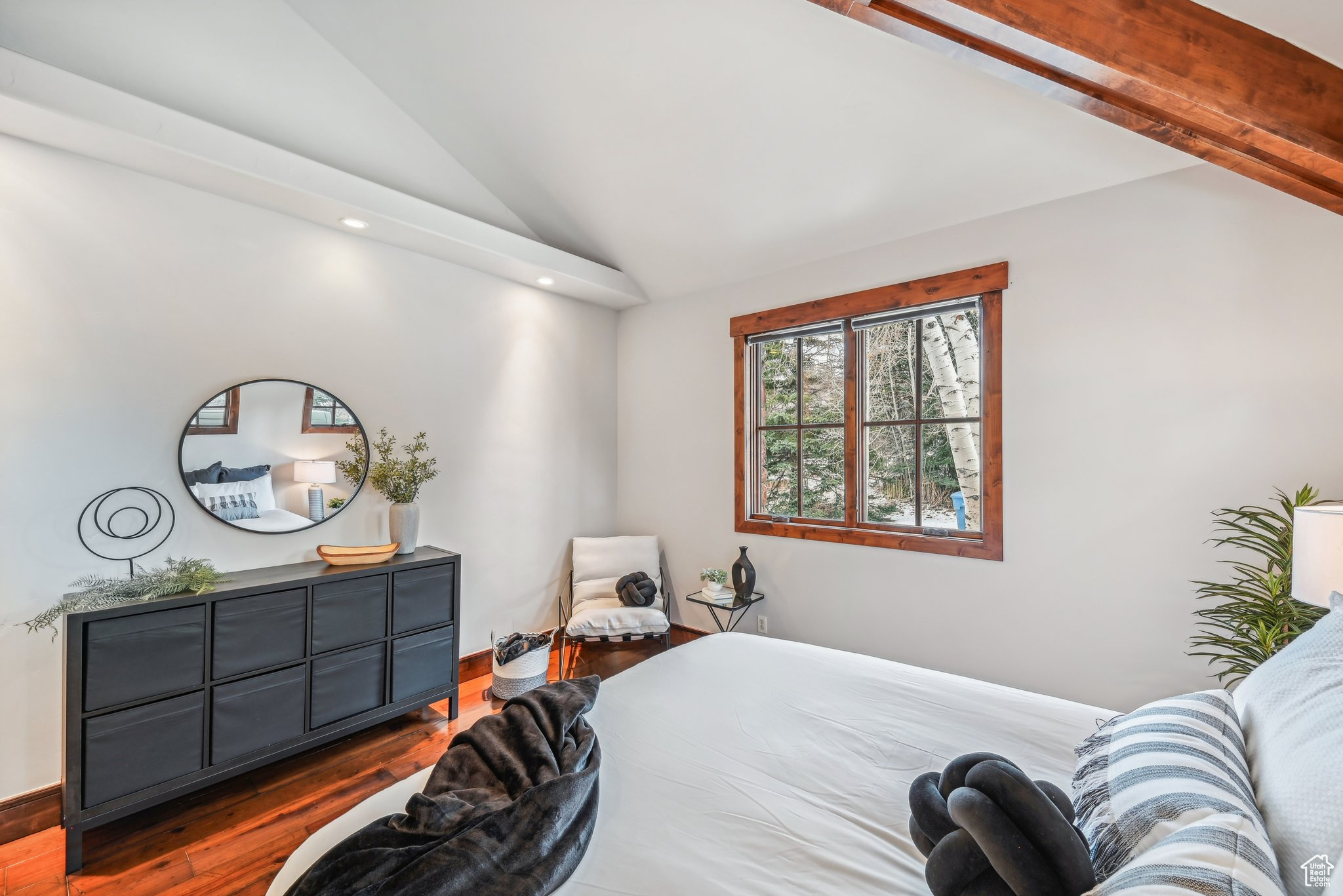 Bedroom featuring hardwood / wood-style floors and lofted ceiling