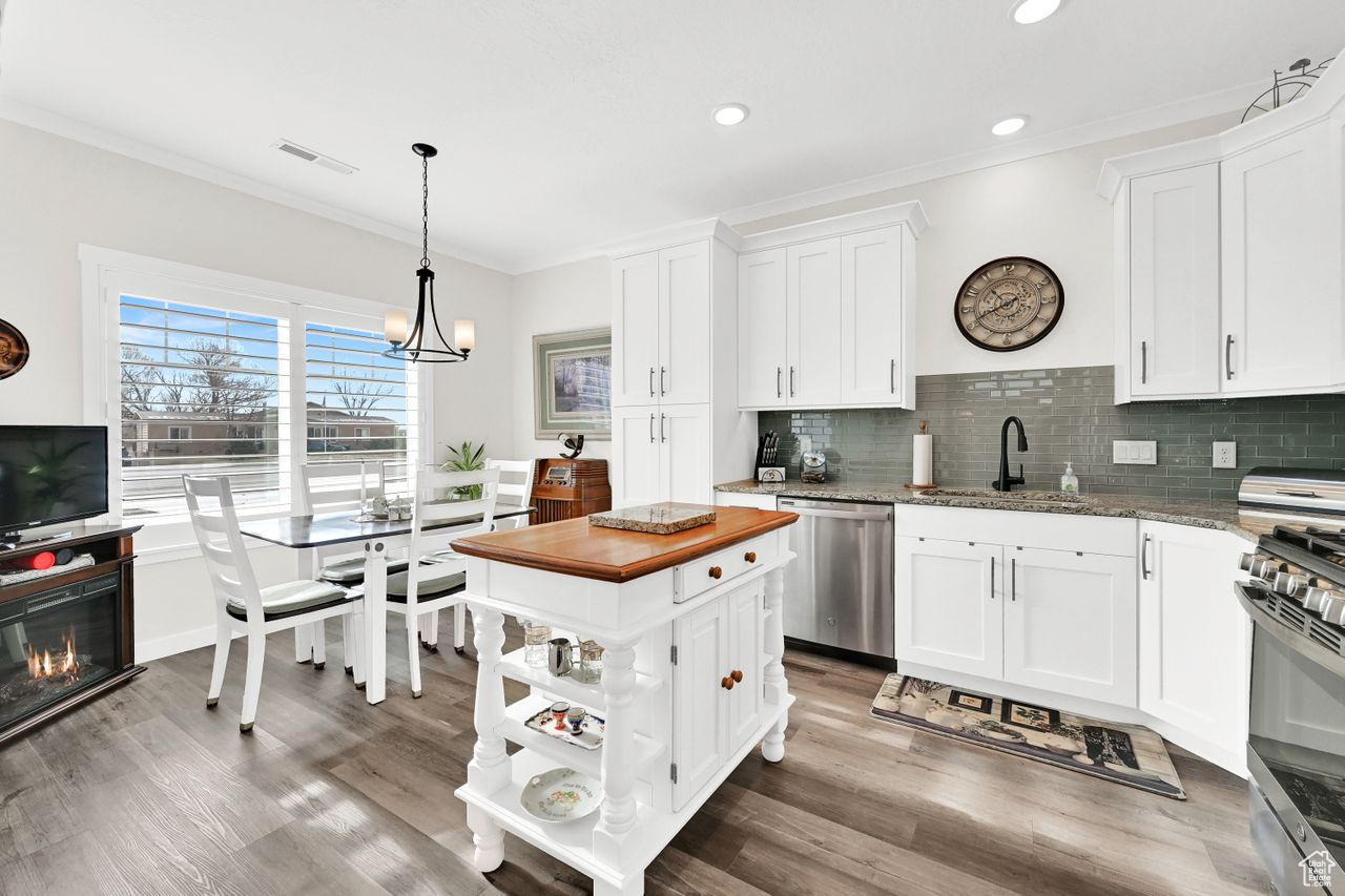 Full kitchen is beautifully arranged with island and dining.