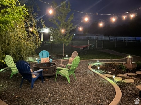 Yard at twilight featuring an outdoor fire pit