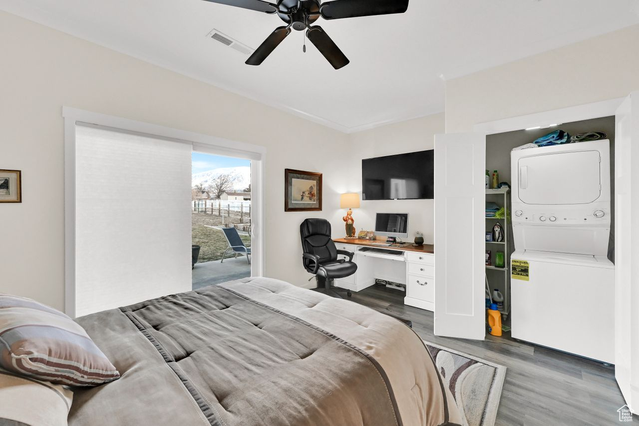 Bedroom featuring stacked washer and dryer inside a seperate closet.