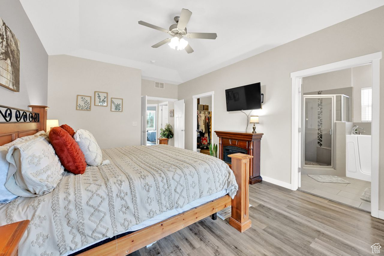 Bedroom featuring ensuite bath and a large walk in closet.