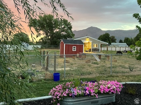 Yard at dusk with a mountain view and a storage shed