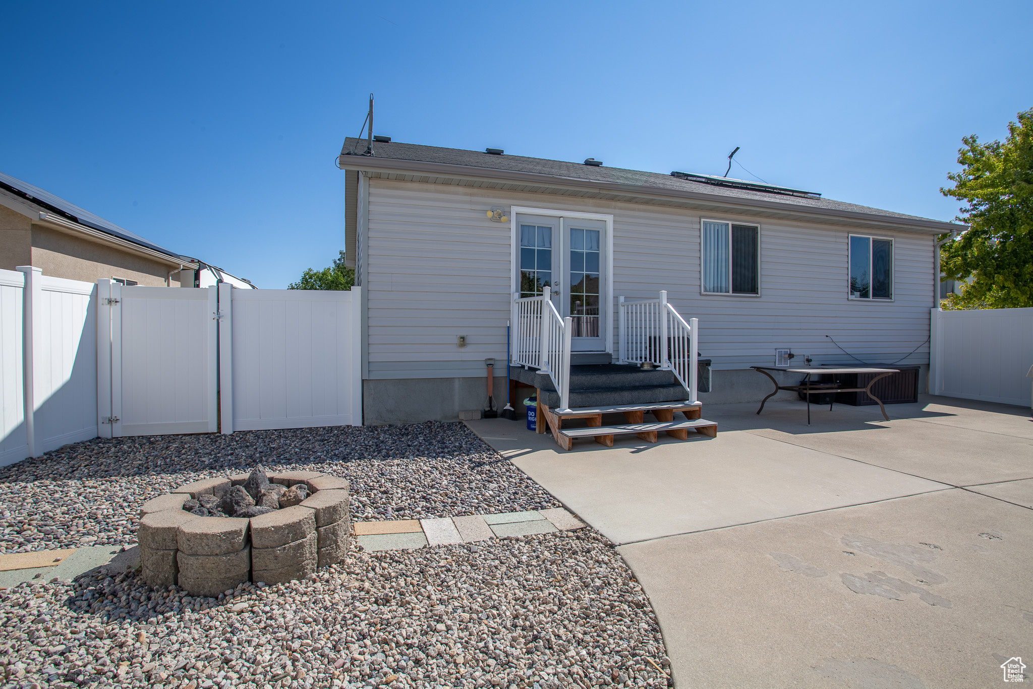 Rear view of property with a fire pit and a patio