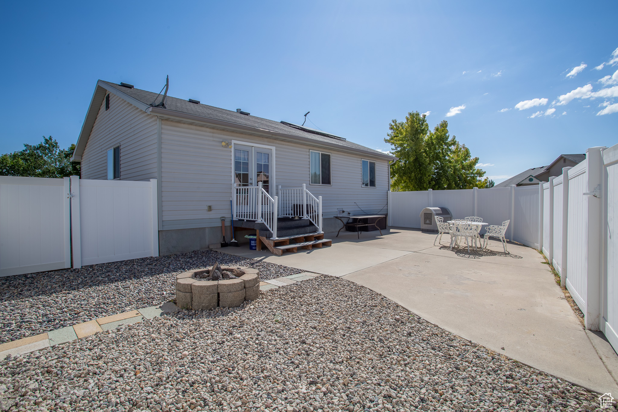 Back of house with a patio and a fire pit