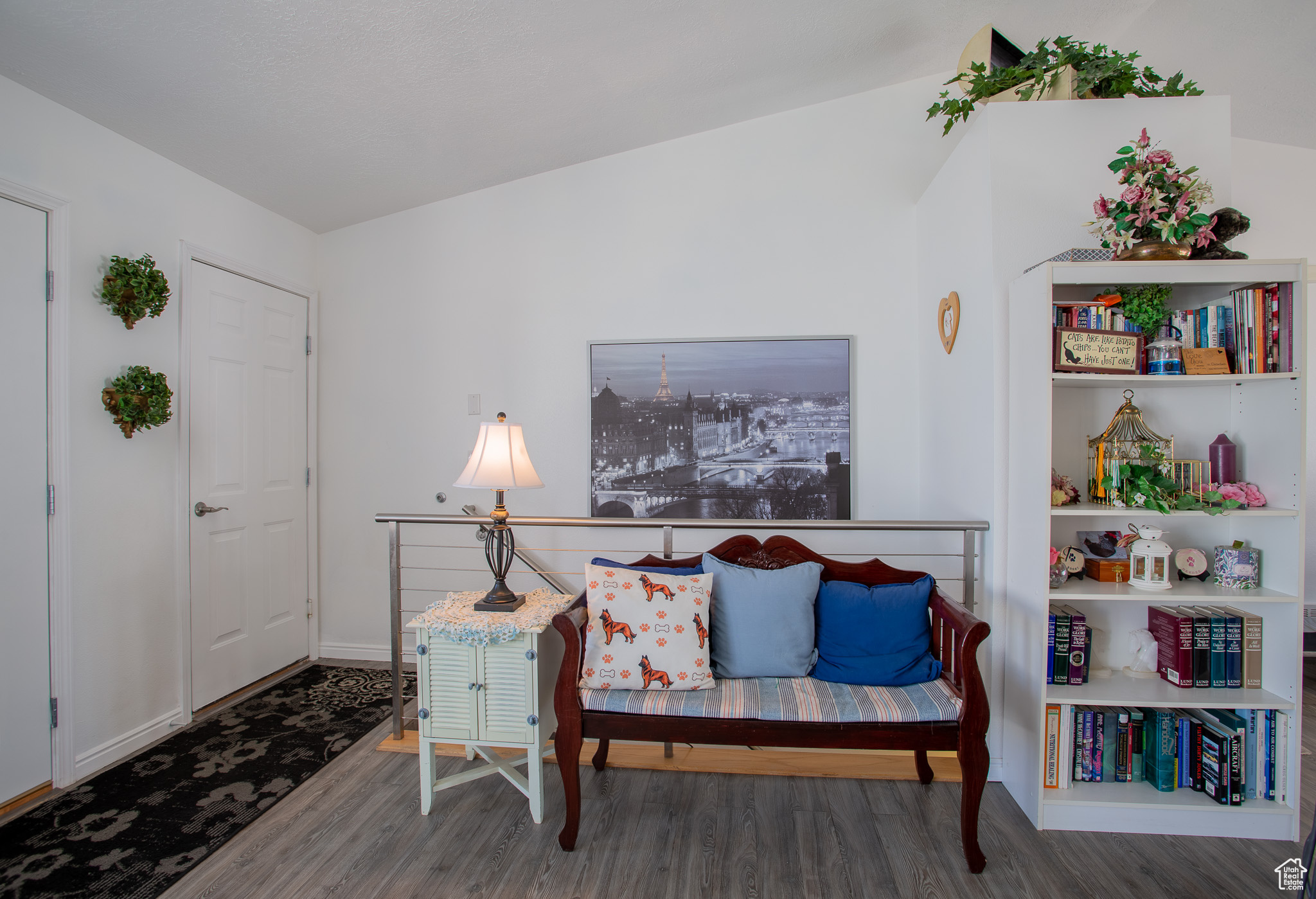 Sitting room with lofted ceiling and dark wood-type flooring