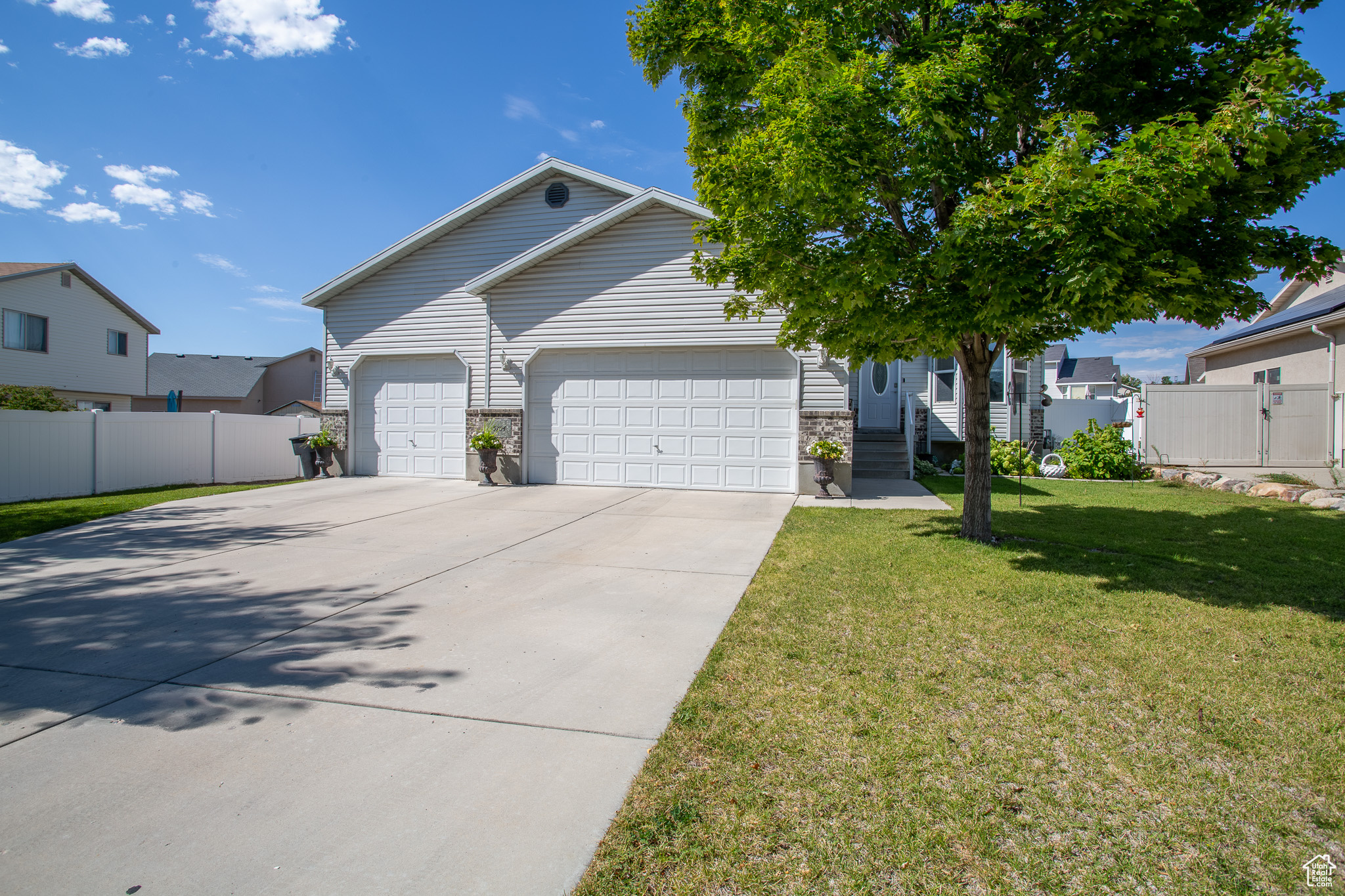 View of front of home with a front yard and a garage