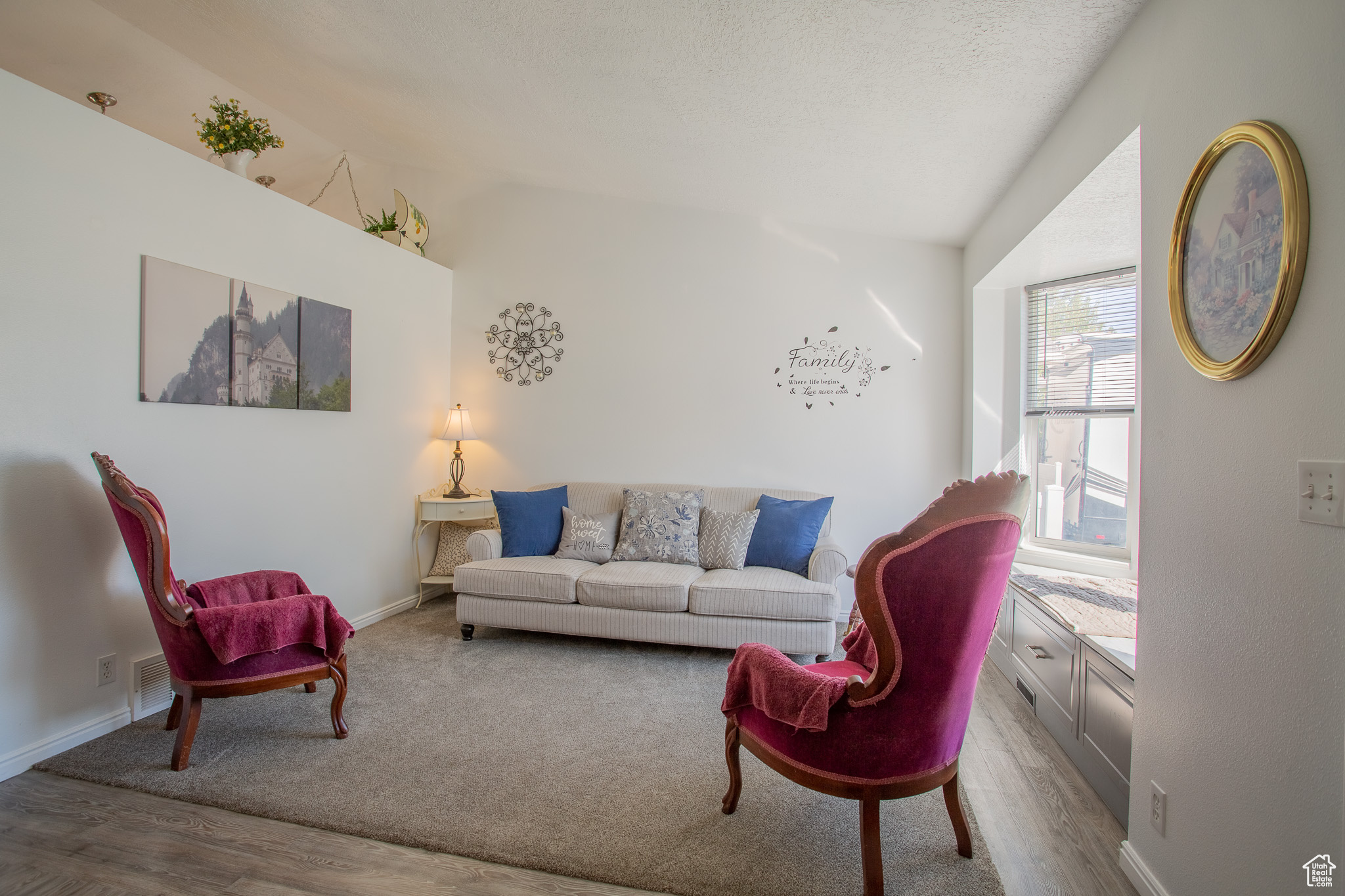 Living room with wood-type flooring and vaulted ceiling