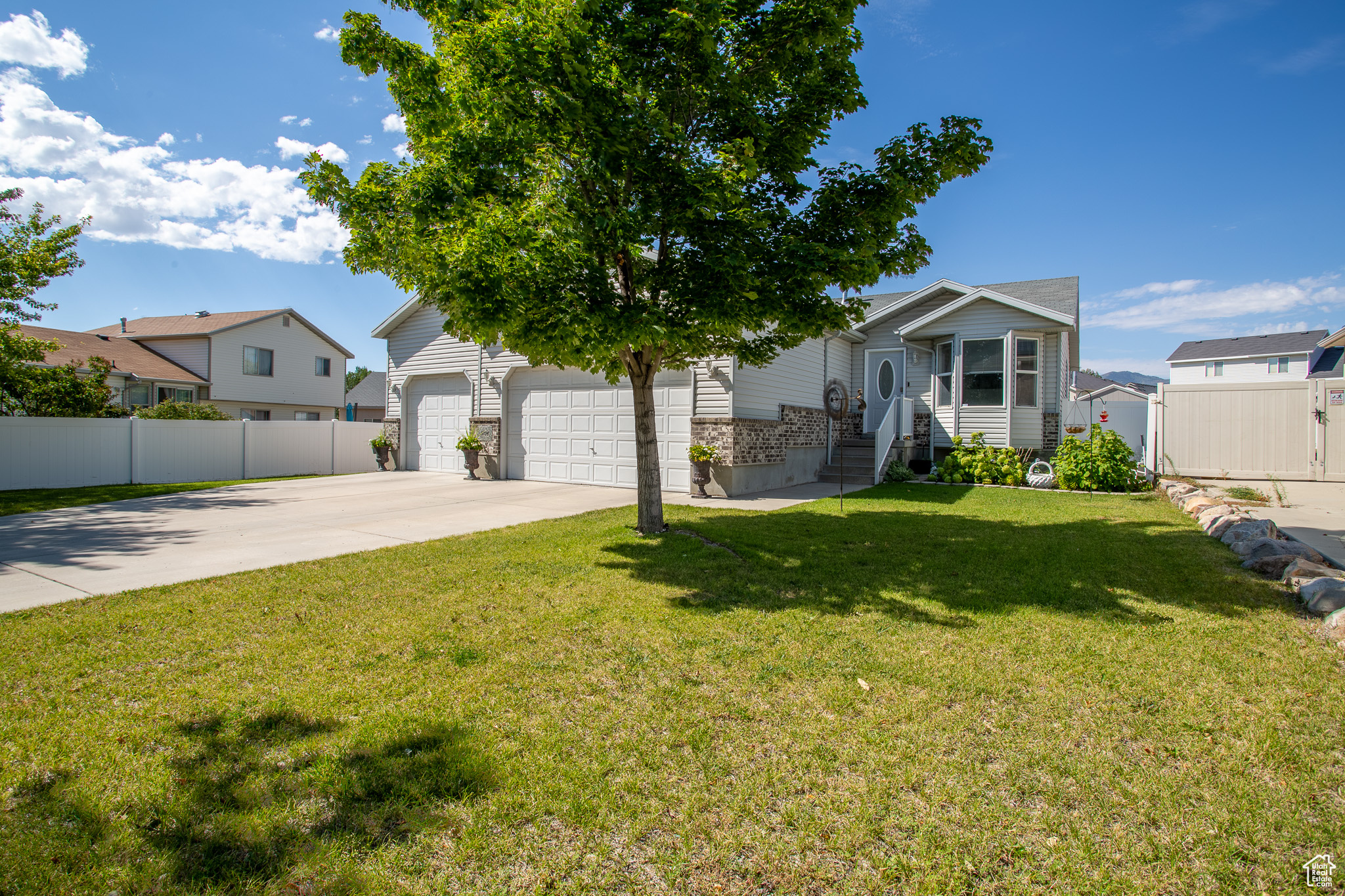 View of front facade with a garage and a front lawn