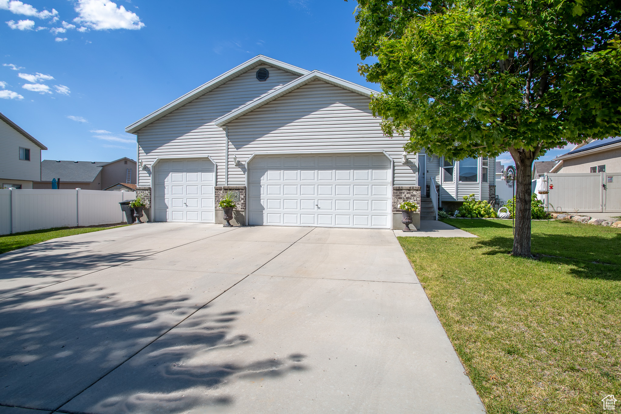 View of front of house with a garage and a front yard