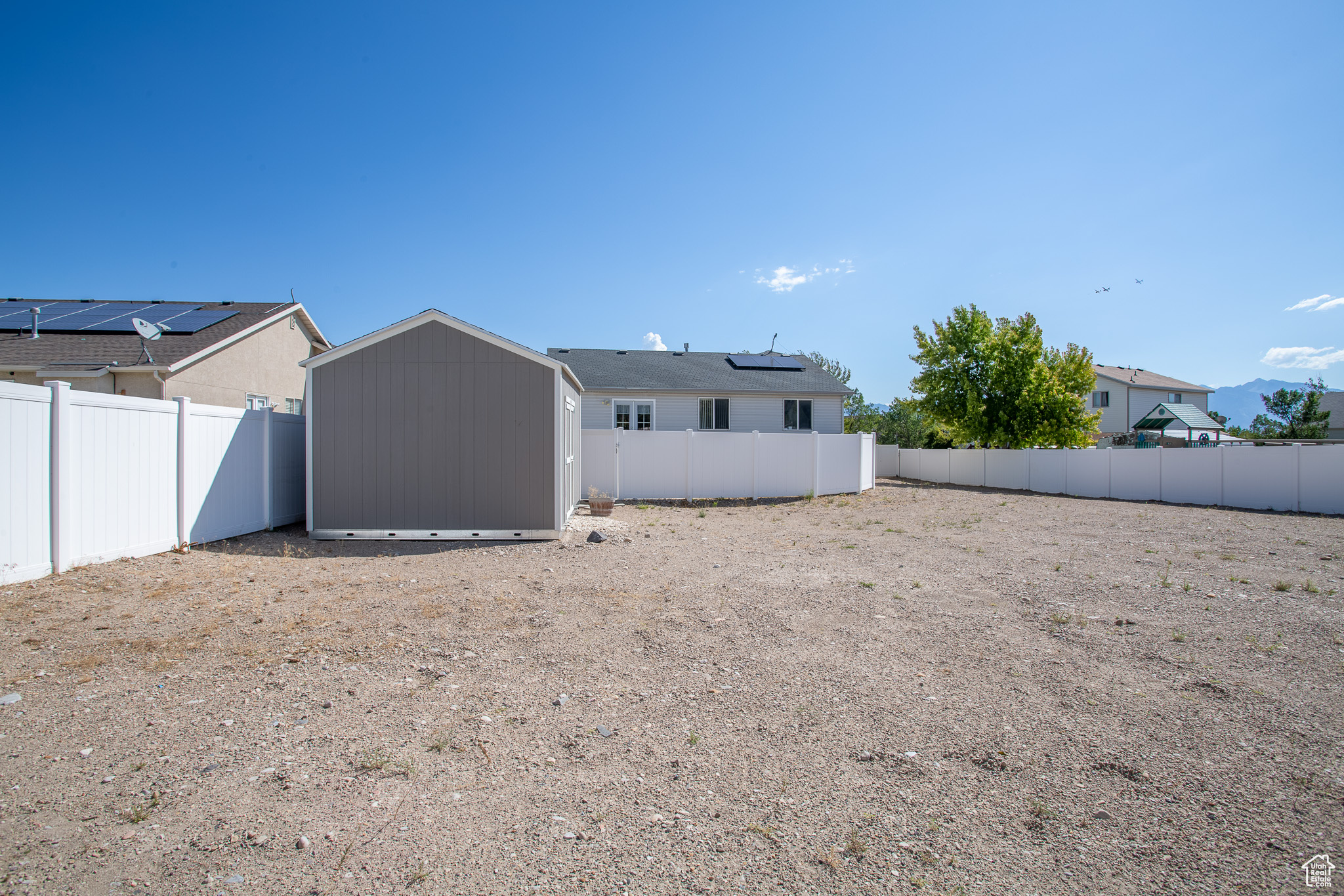 Back of property with a storage shed