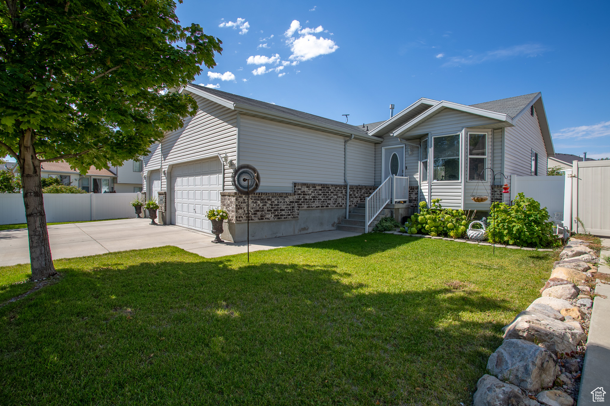 View of front of home featuring a garage and a front lawn