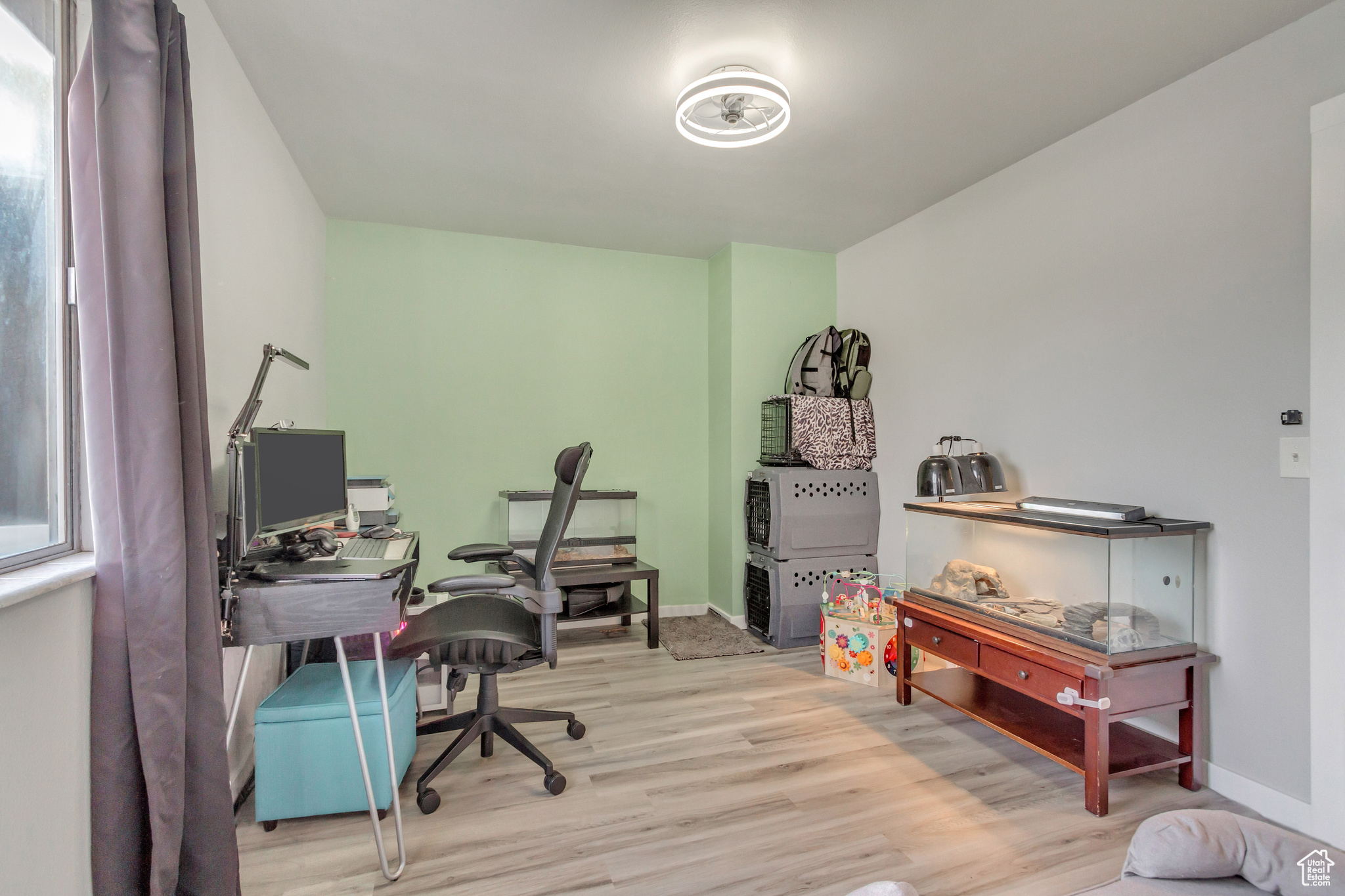 Home office with light wood-type flooring