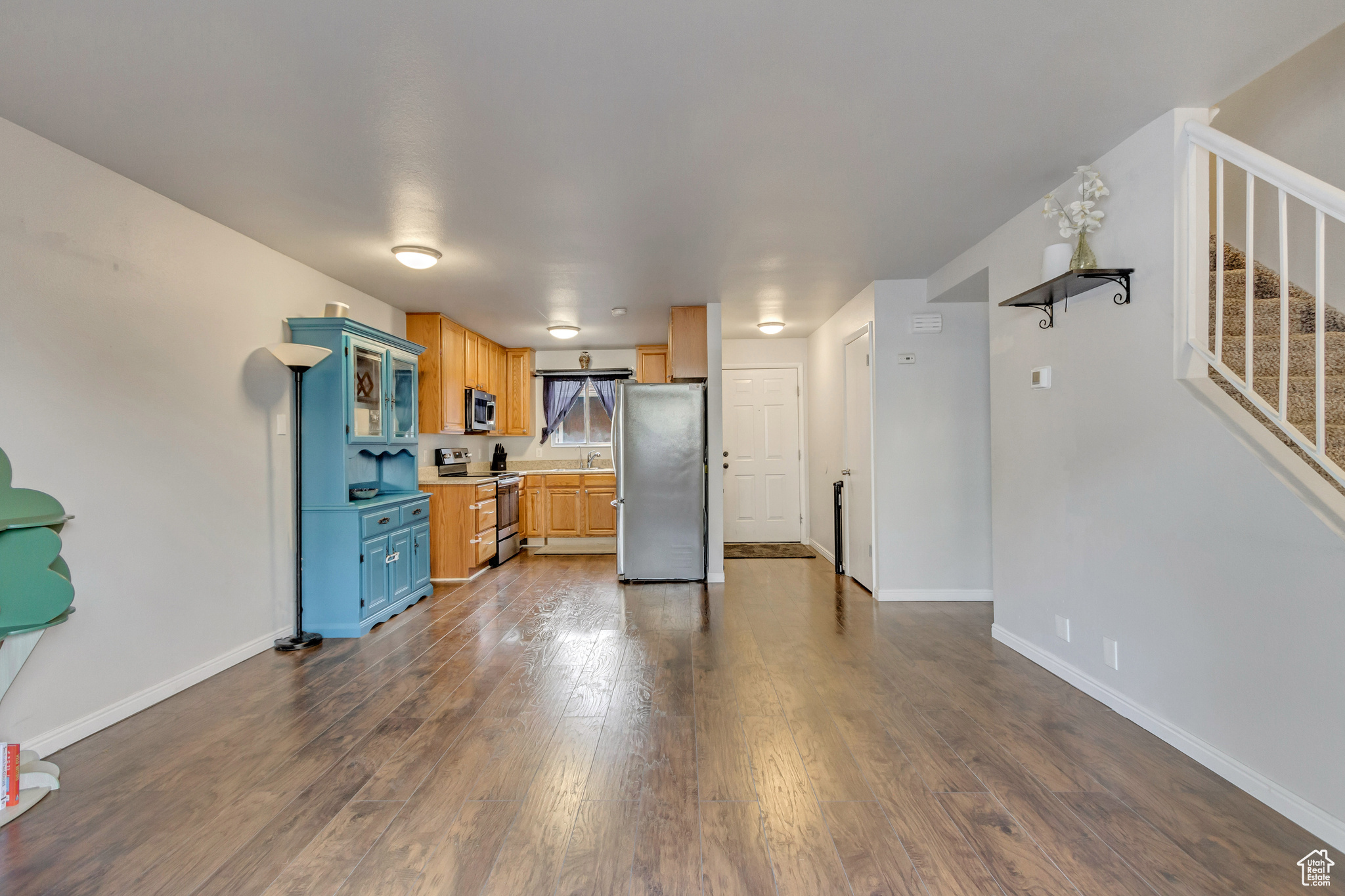 Kitchen featuring dark wood-type flooring and stainless steel appliances