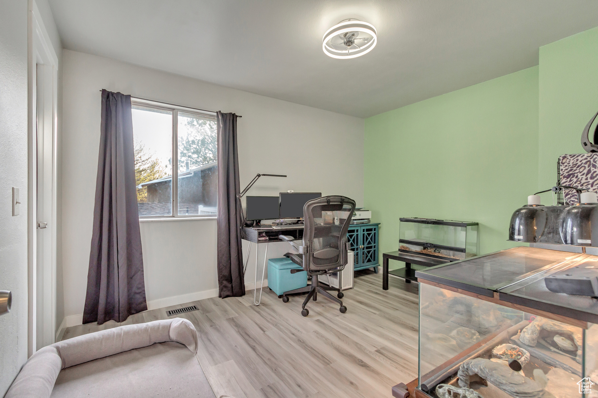 Office with light hardwood / wood-style floors