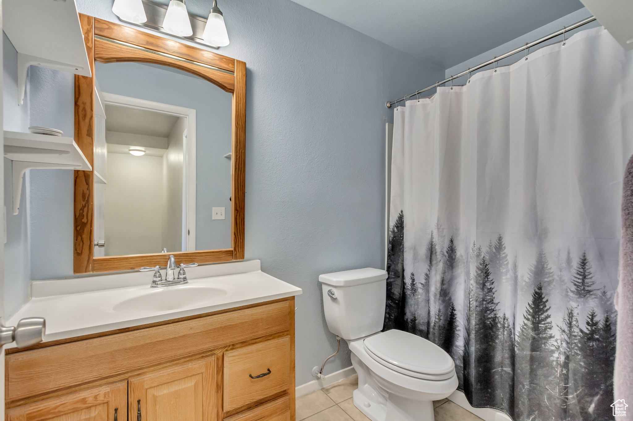 Bathroom featuring tile patterned floors, vanity, and toilet