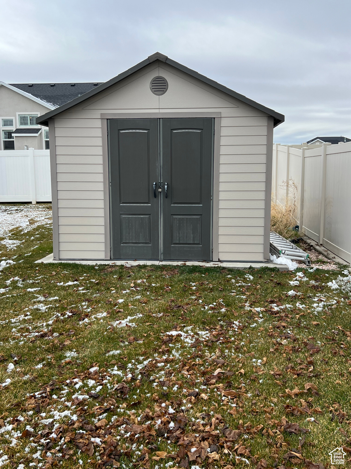 View of outdoor structure featuring a lawn