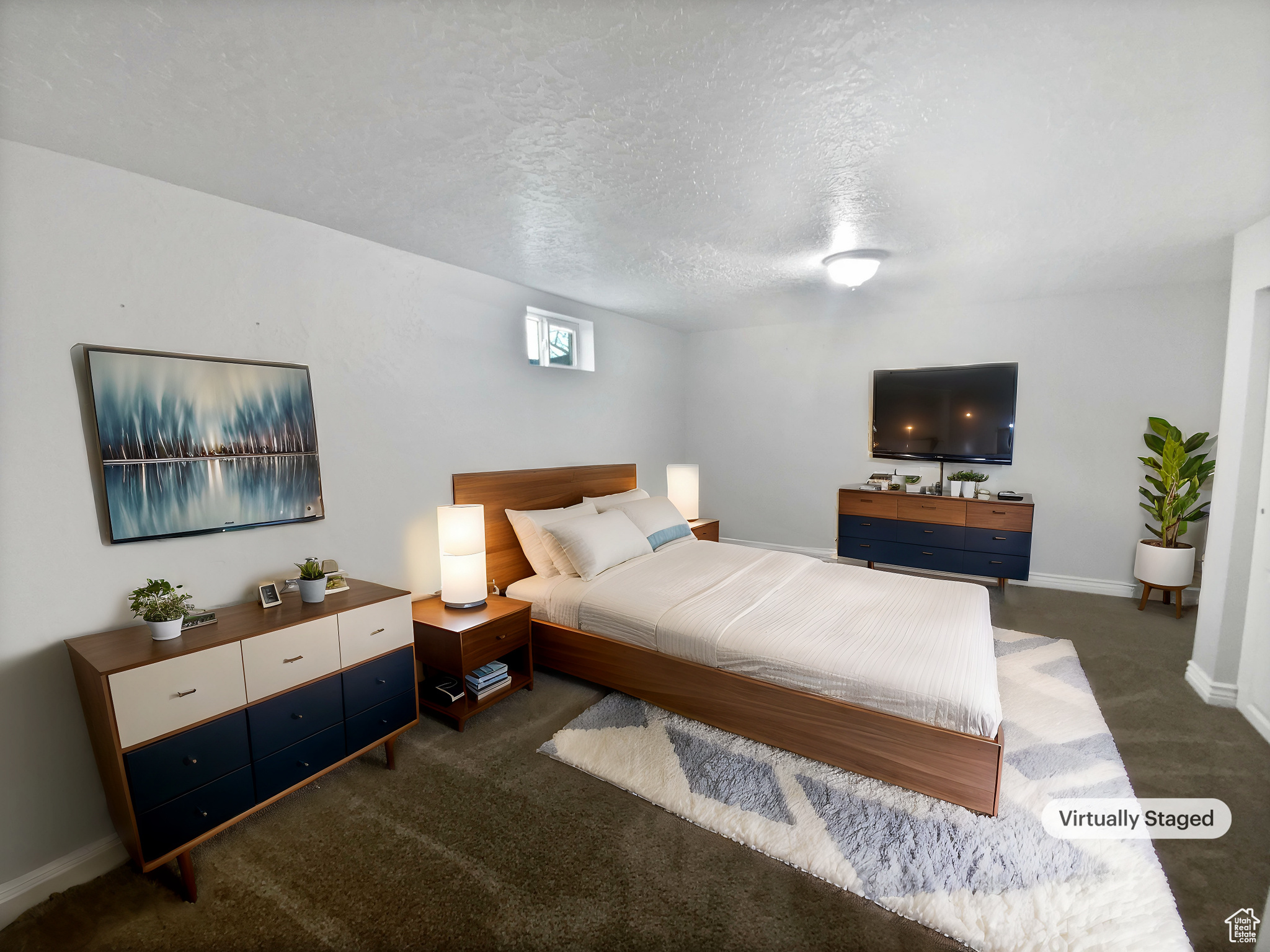 Carpeted bedroom with a textured ceiling