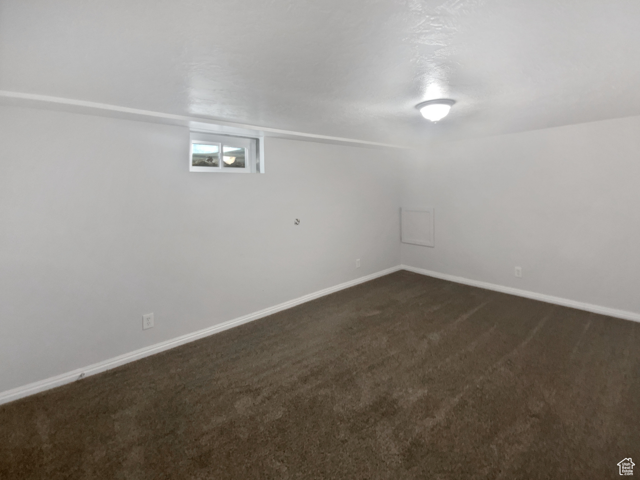 Basement featuring dark colored carpet