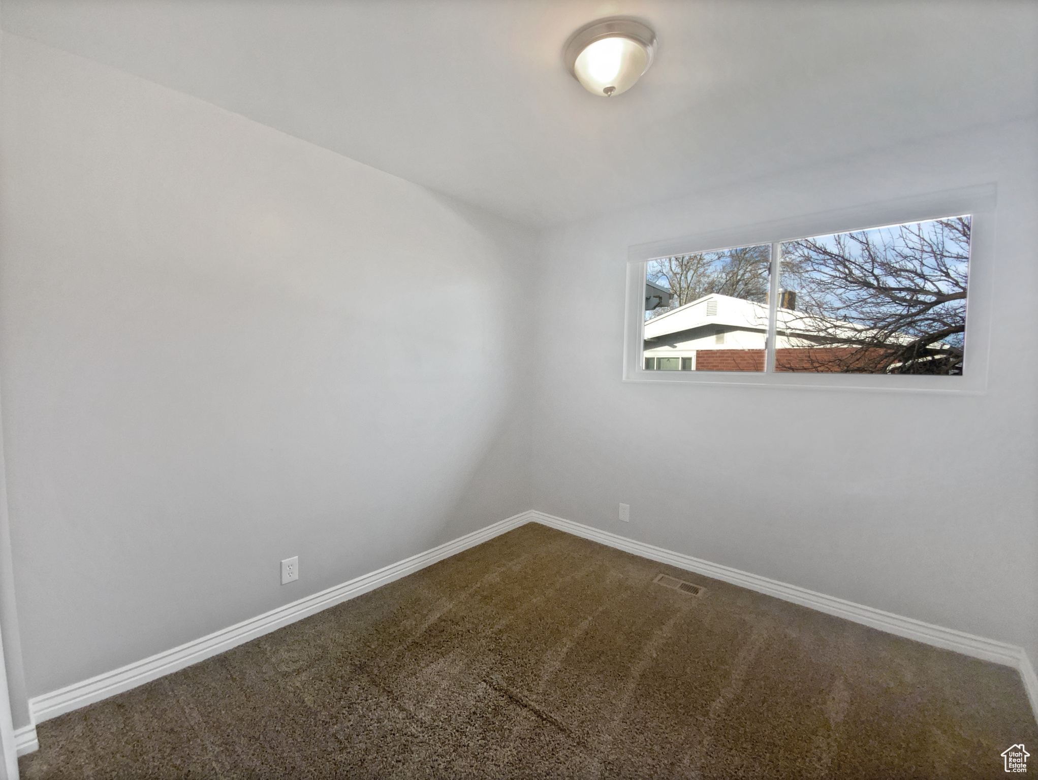 Empty room with carpet flooring