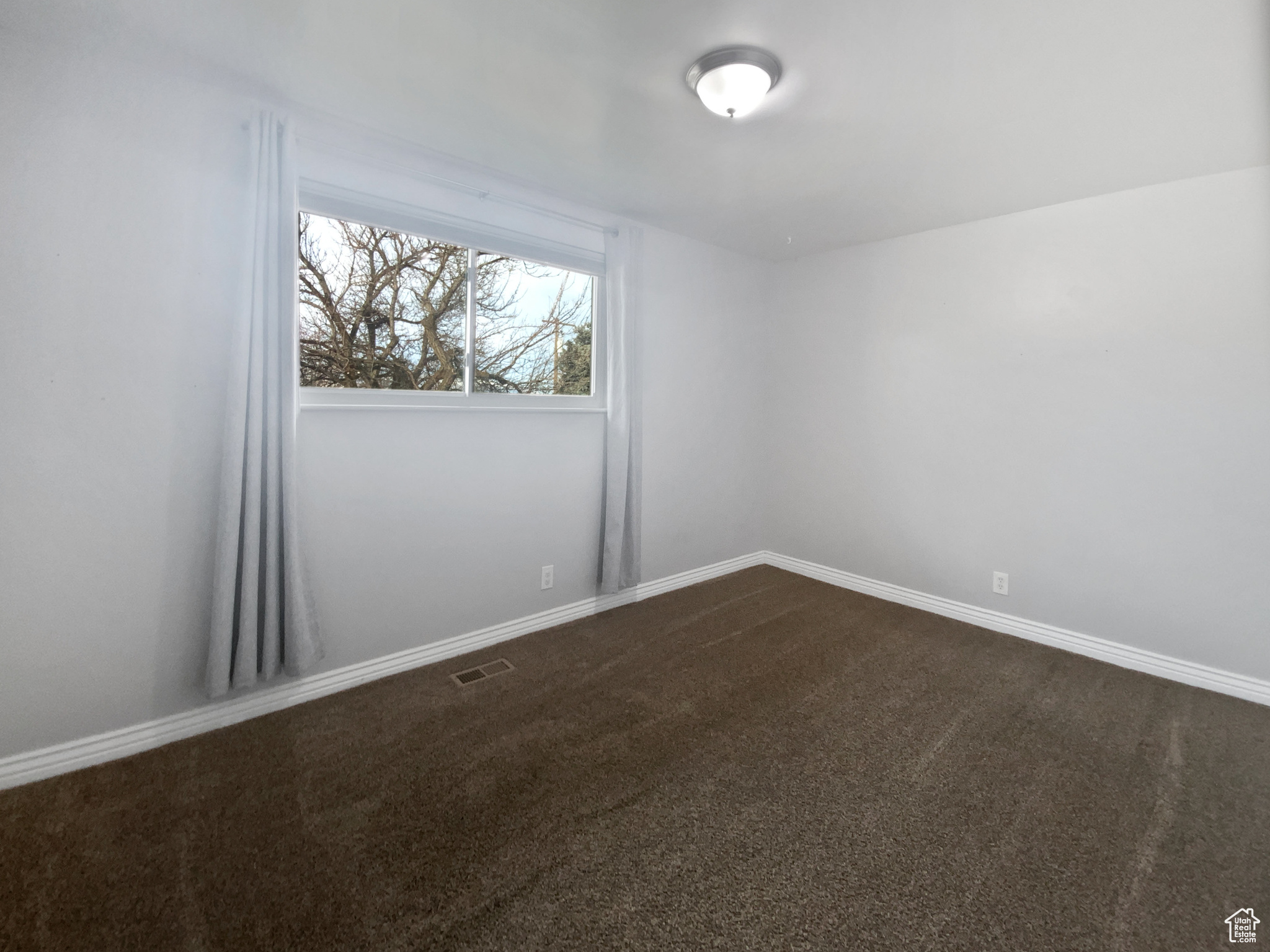 Spare room featuring carpet floors