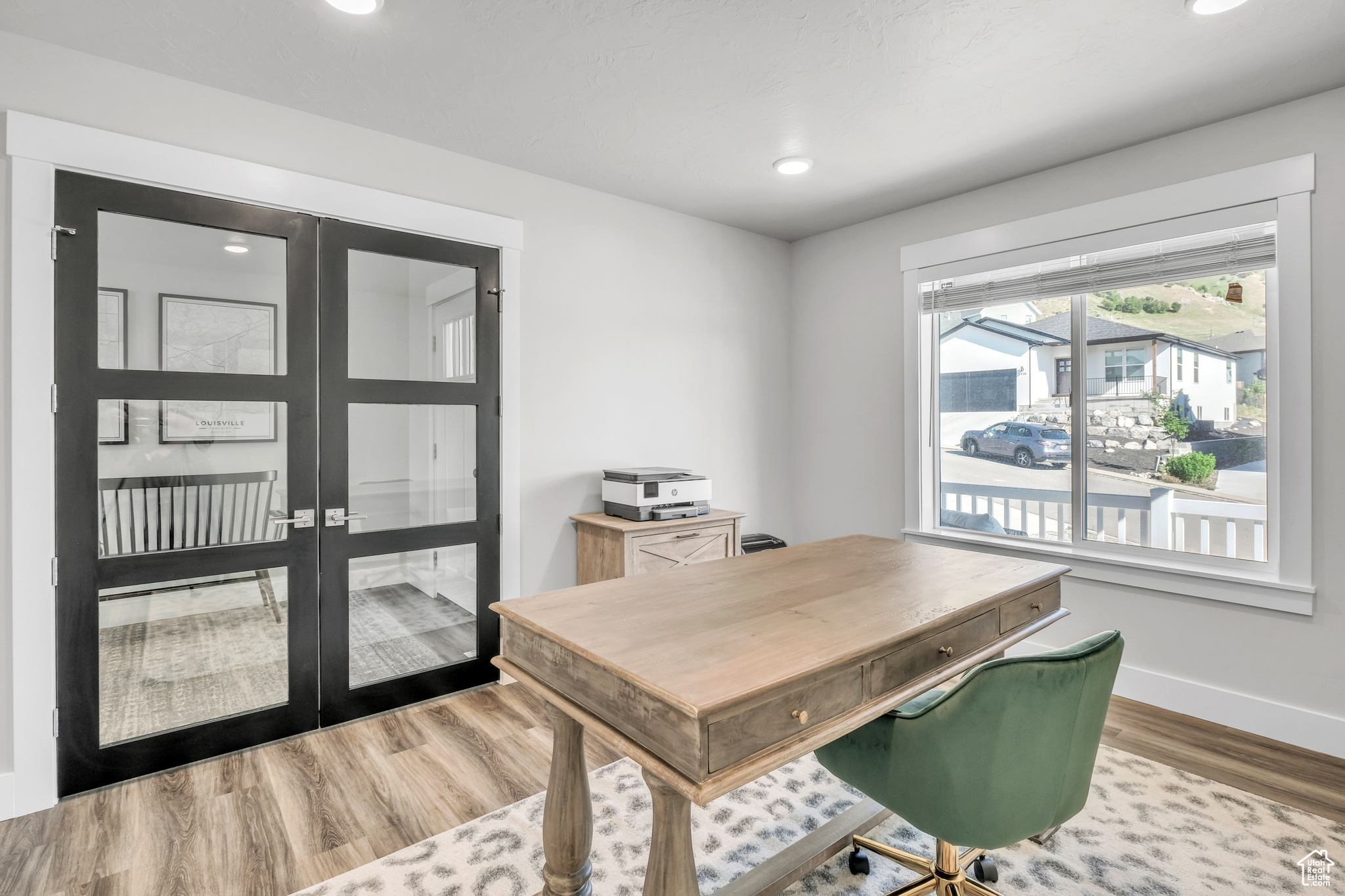 Office space with hardwood / wood-style floors