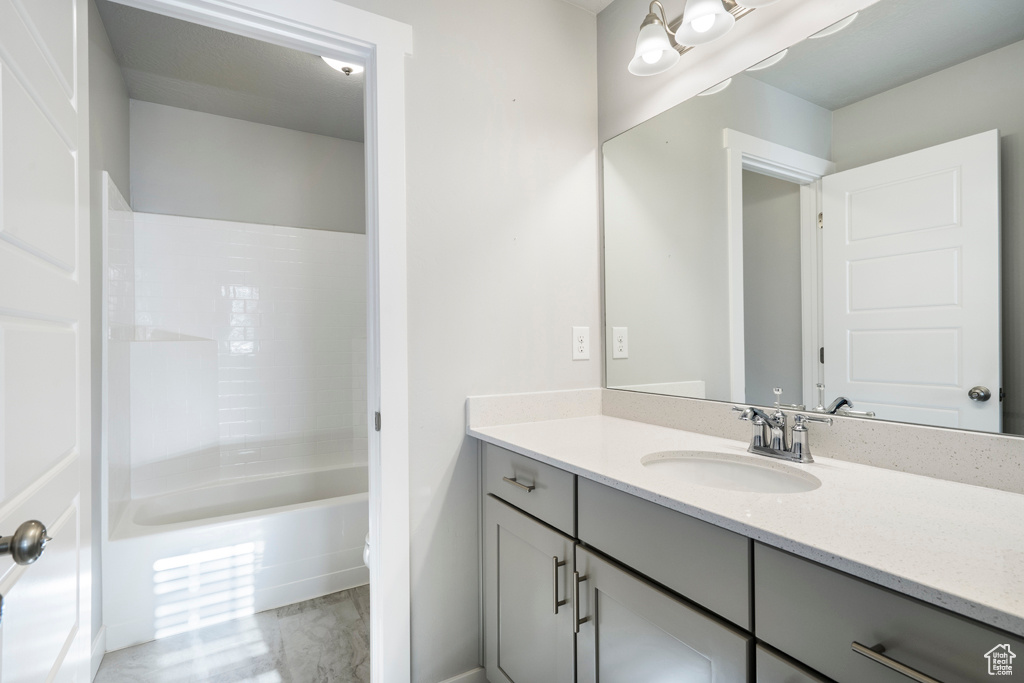 Bathroom featuring bathtub / shower combination and vanity