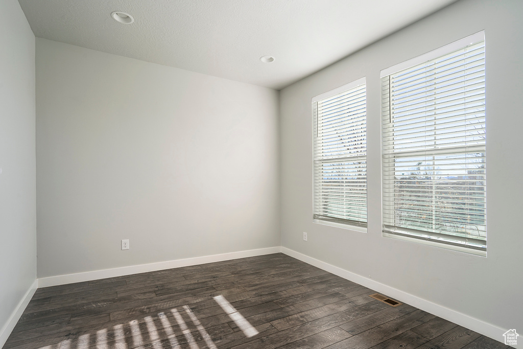 Unfurnished room featuring dark hardwood / wood-style floors