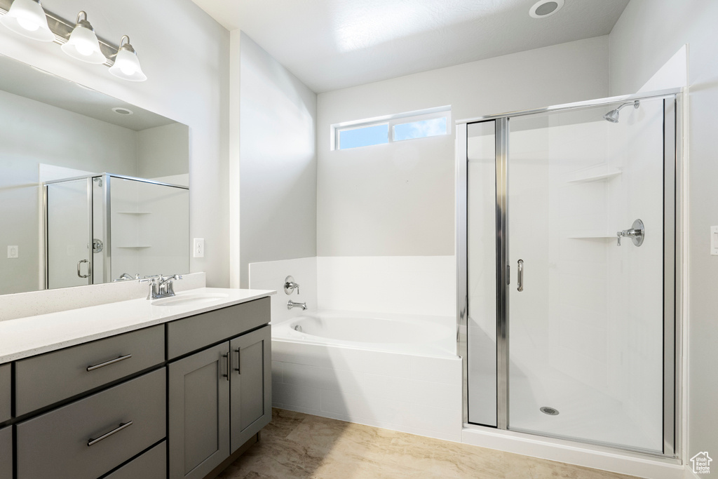 Bathroom with vanity and plus walk in shower