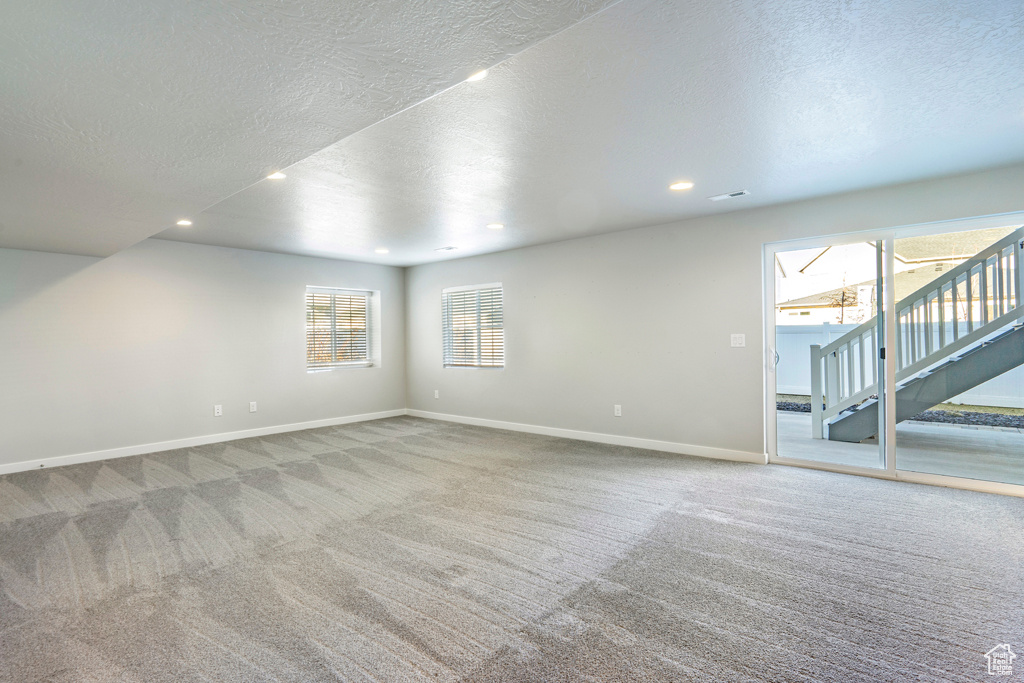 Unfurnished room with carpet floors and a textured ceiling