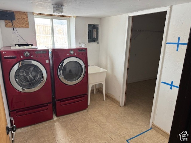 Clothes washing area featuring independent washer and dryer and electric panel