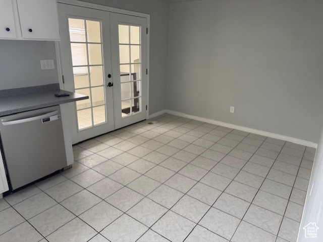 Entryway featuring french doors and light tile patterned flooring