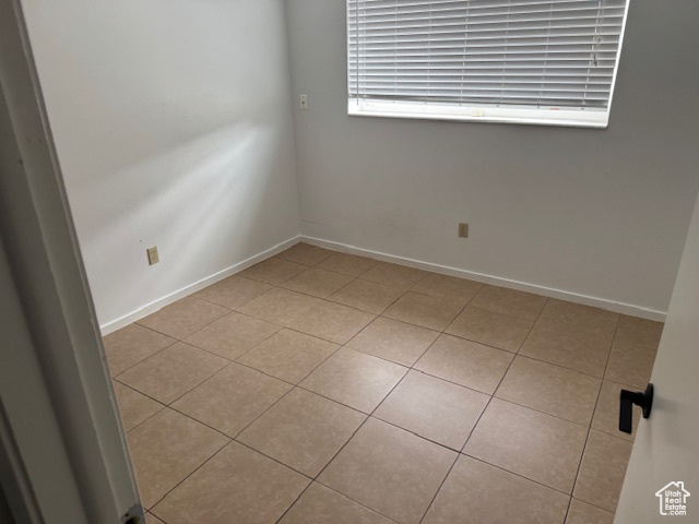 Spare room featuring light tile patterned floors