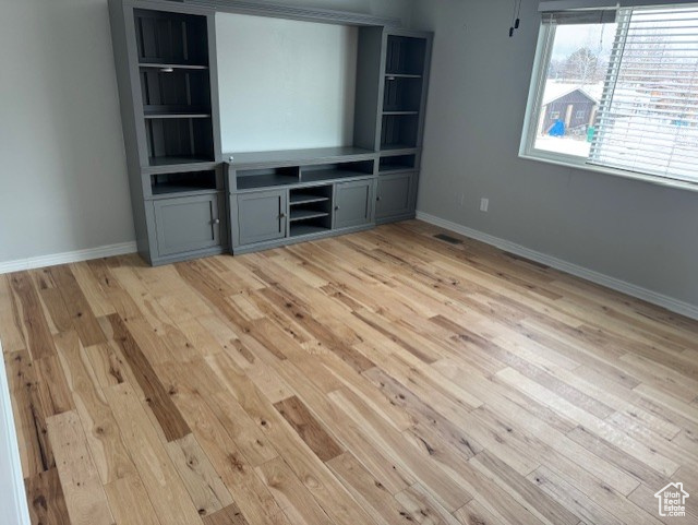 Unfurnished living room featuring light wood-type flooring