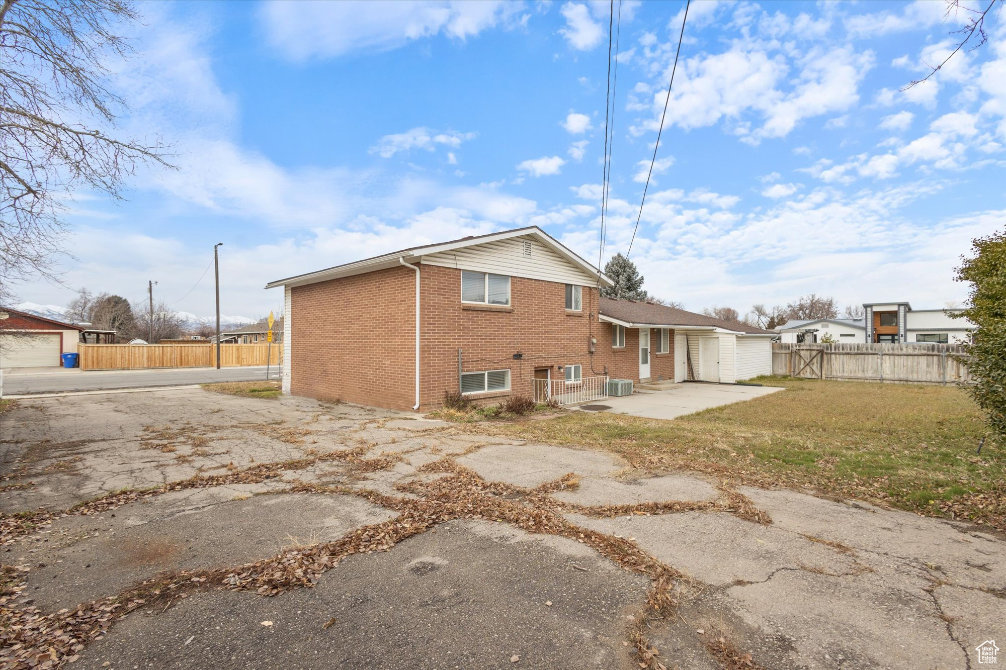 Rear view of property featuring a patio area and a lawn