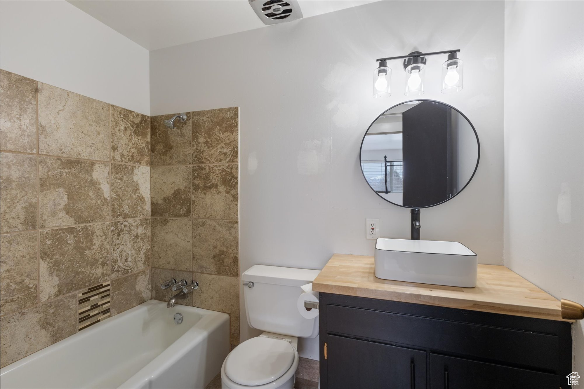 Bathroom featuring vanity and toilet