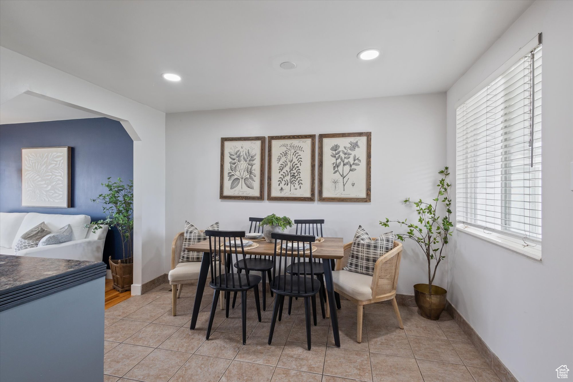 Dining area featuring plenty of natural light and light tile patterned flooring