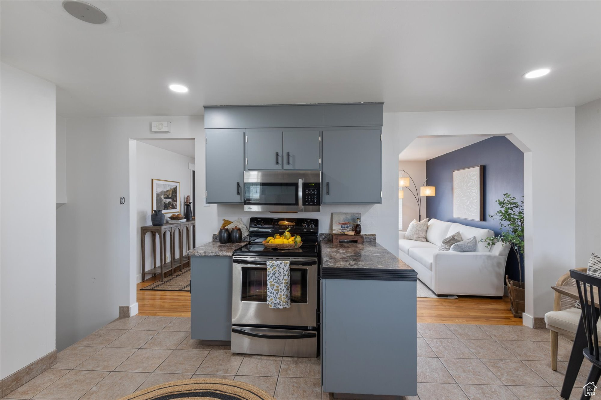 Kitchen with light tile patterned floors and stainless steel appliances