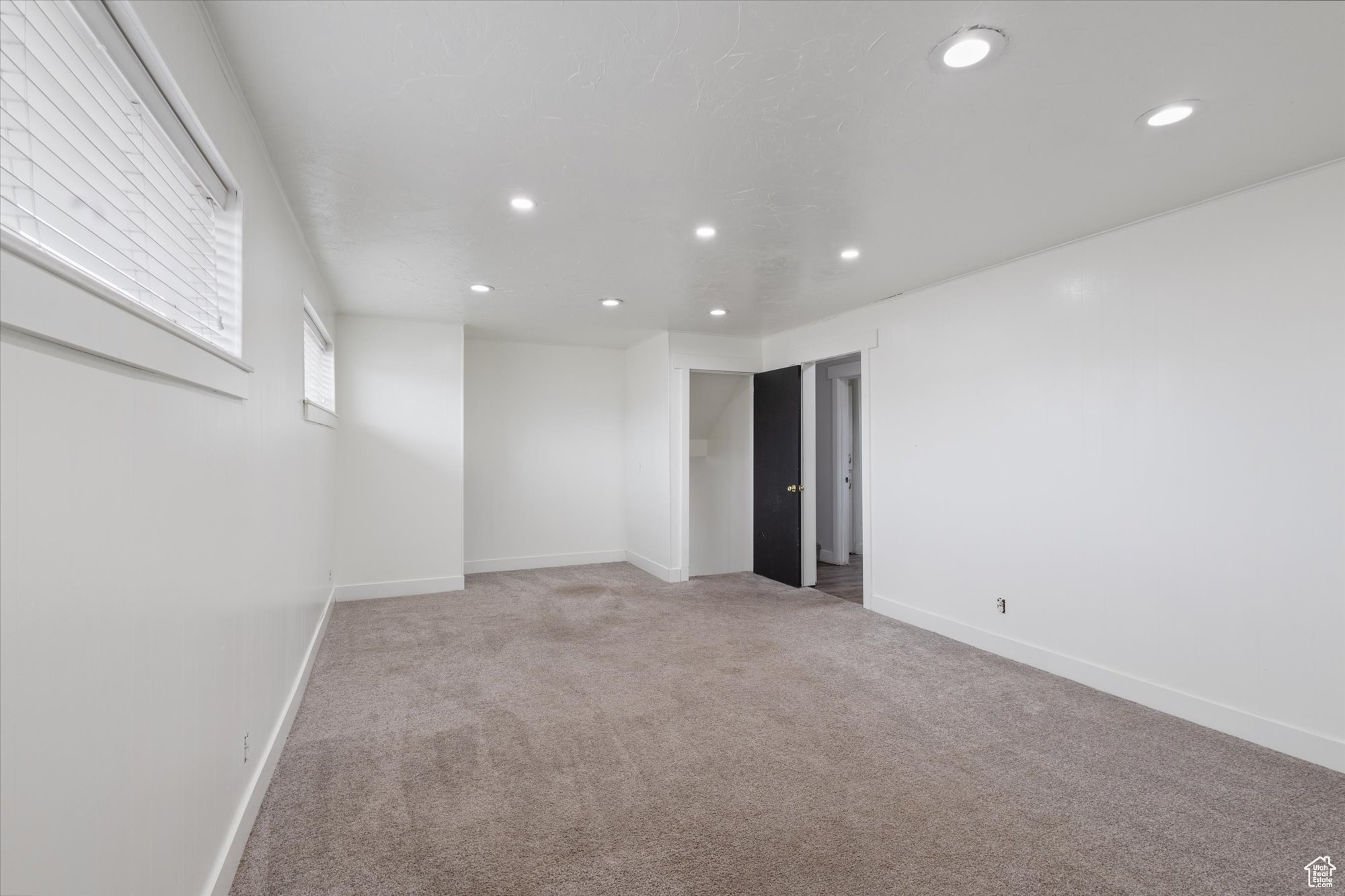 Spare room featuring light colored carpet