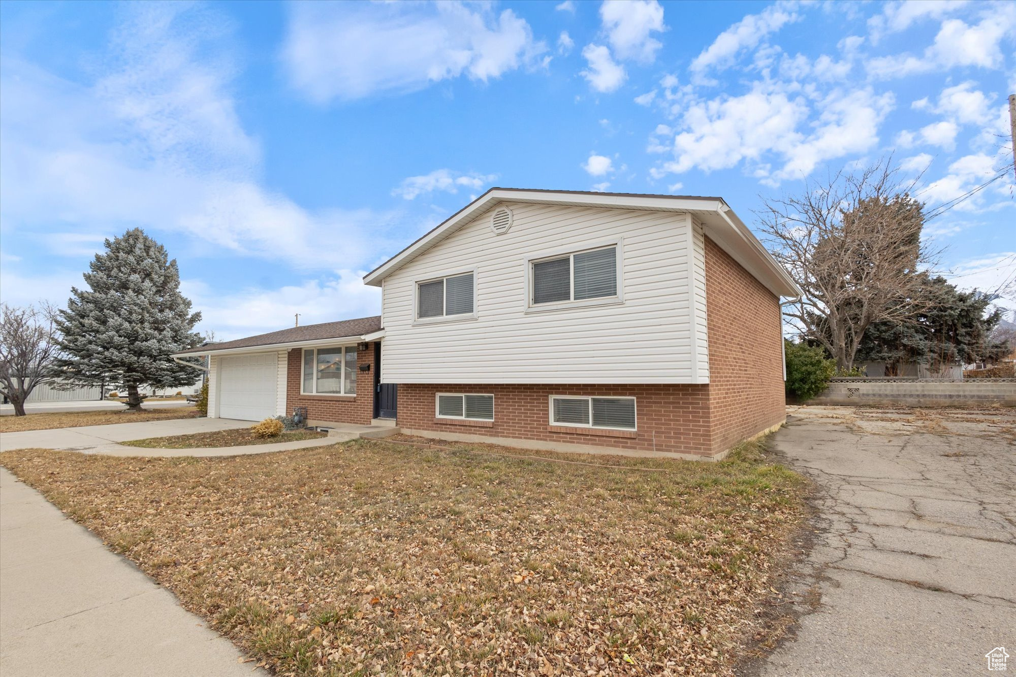 Split level home with a garage and a front lawn