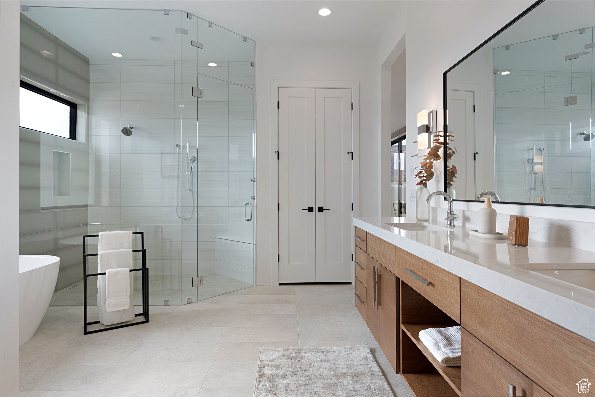 Bathroom with tile patterned flooring, shower with separate bathtub, and vanity