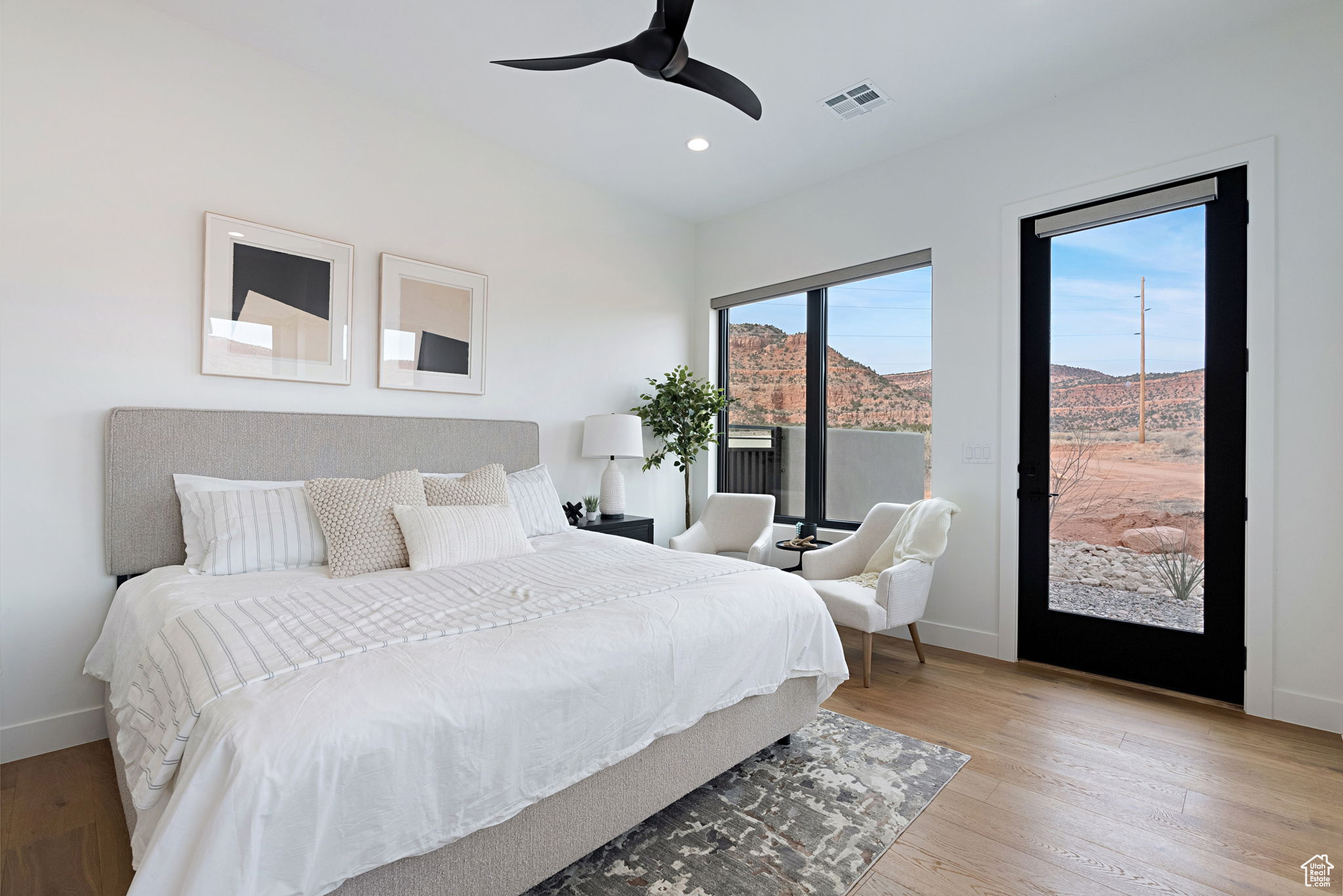 Casita with Kitchenette. Bedroom with a mountain view, ceiling fan, access to outside, and light hardwood / wood-style flooring