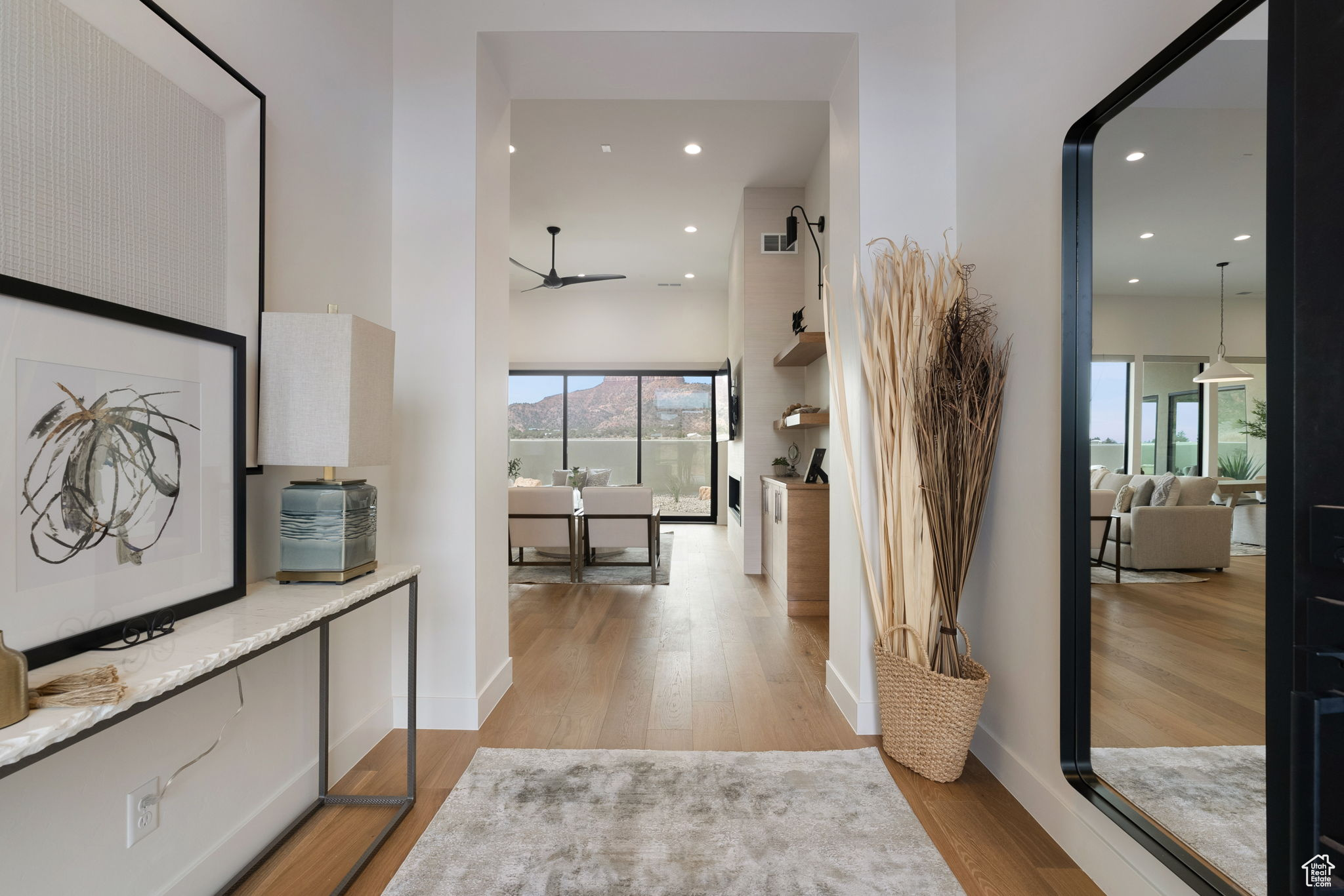 Corridor with a healthy amount of sunlight and light hardwood / wood-style flooring