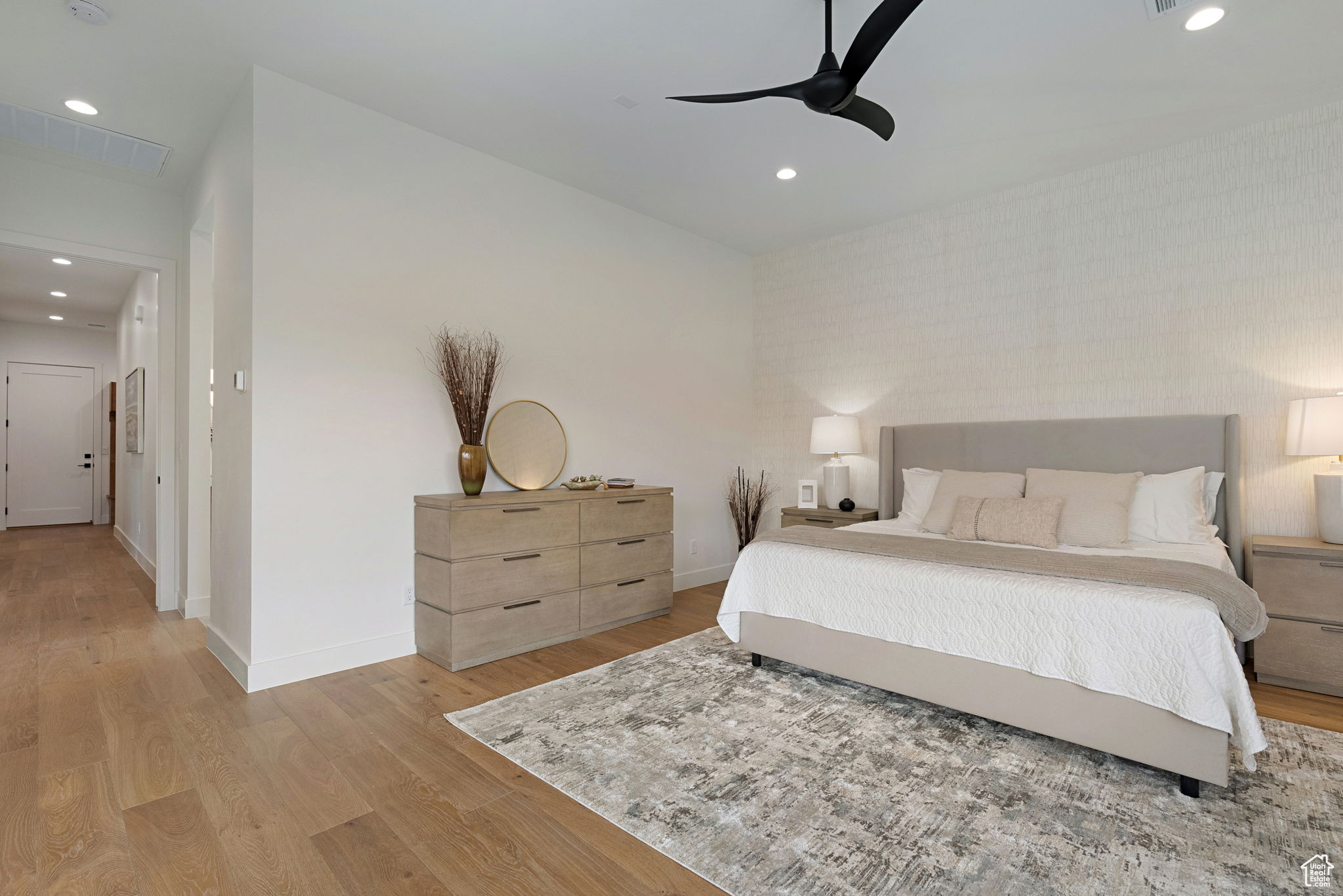 Bedroom featuring ceiling fan and light hardwood / wood-style flooring