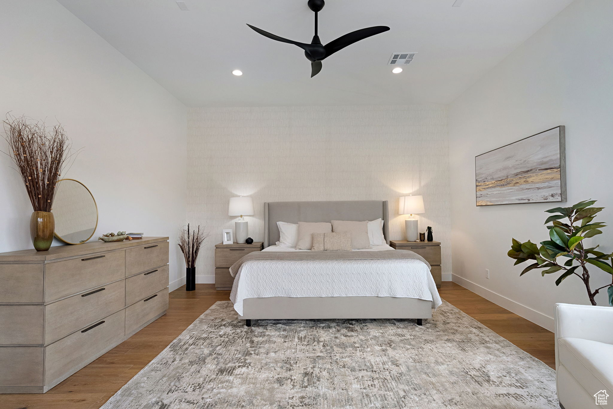 Bedroom with hardwood / wood-style flooring, ceiling fan, and vaulted ceiling