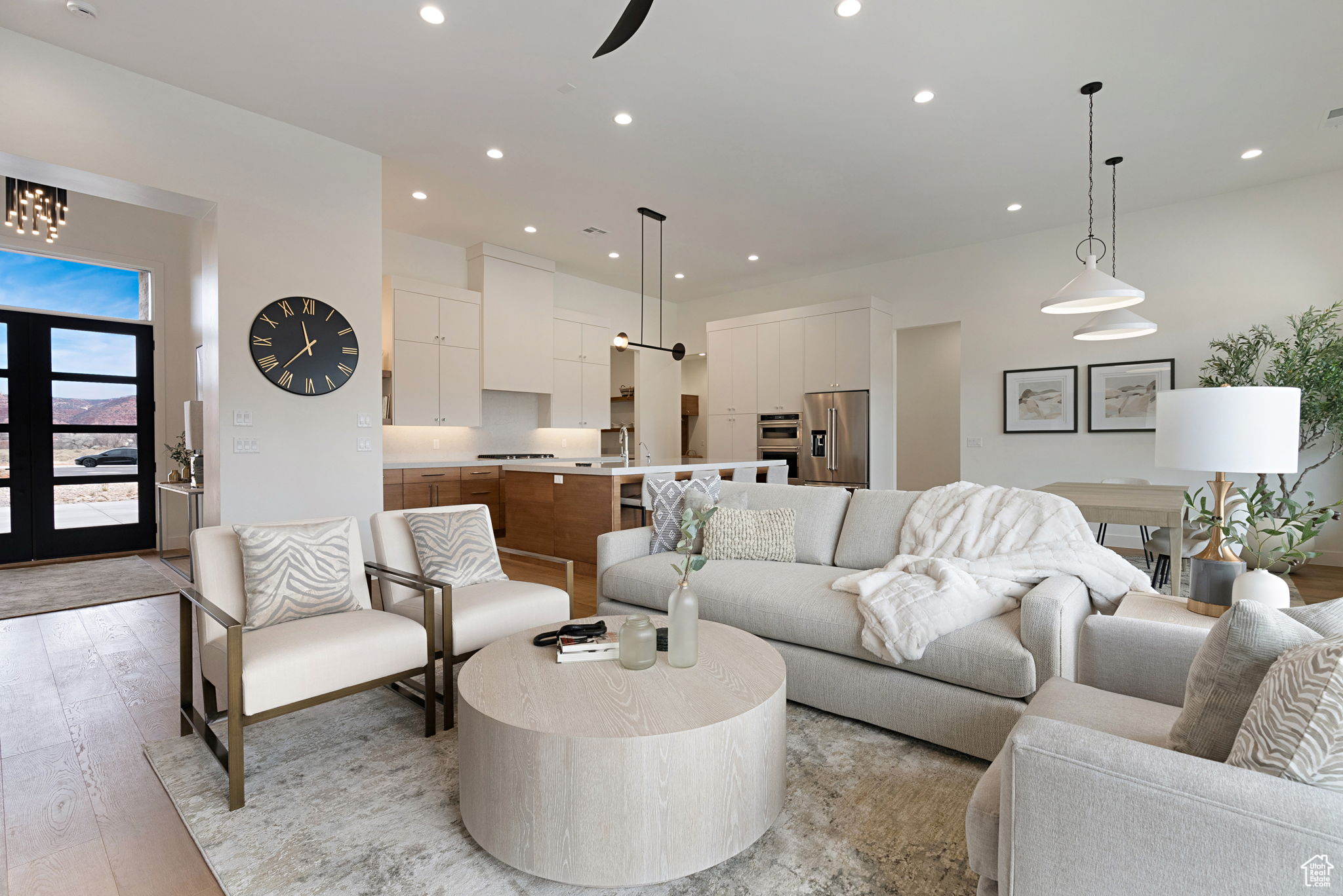 Living room with ceiling fan, sink, and light hardwood / wood-style floors