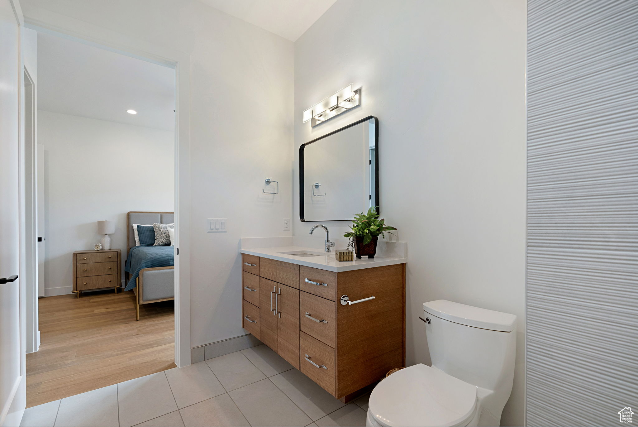 Bathroom featuring tile patterned floors, vanity, and toilet